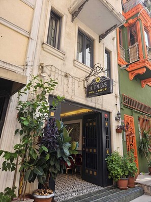 A building with a sign reading 'A PLUS Residence' and a door with a black gate. - A Plus Residence (Istanbul)