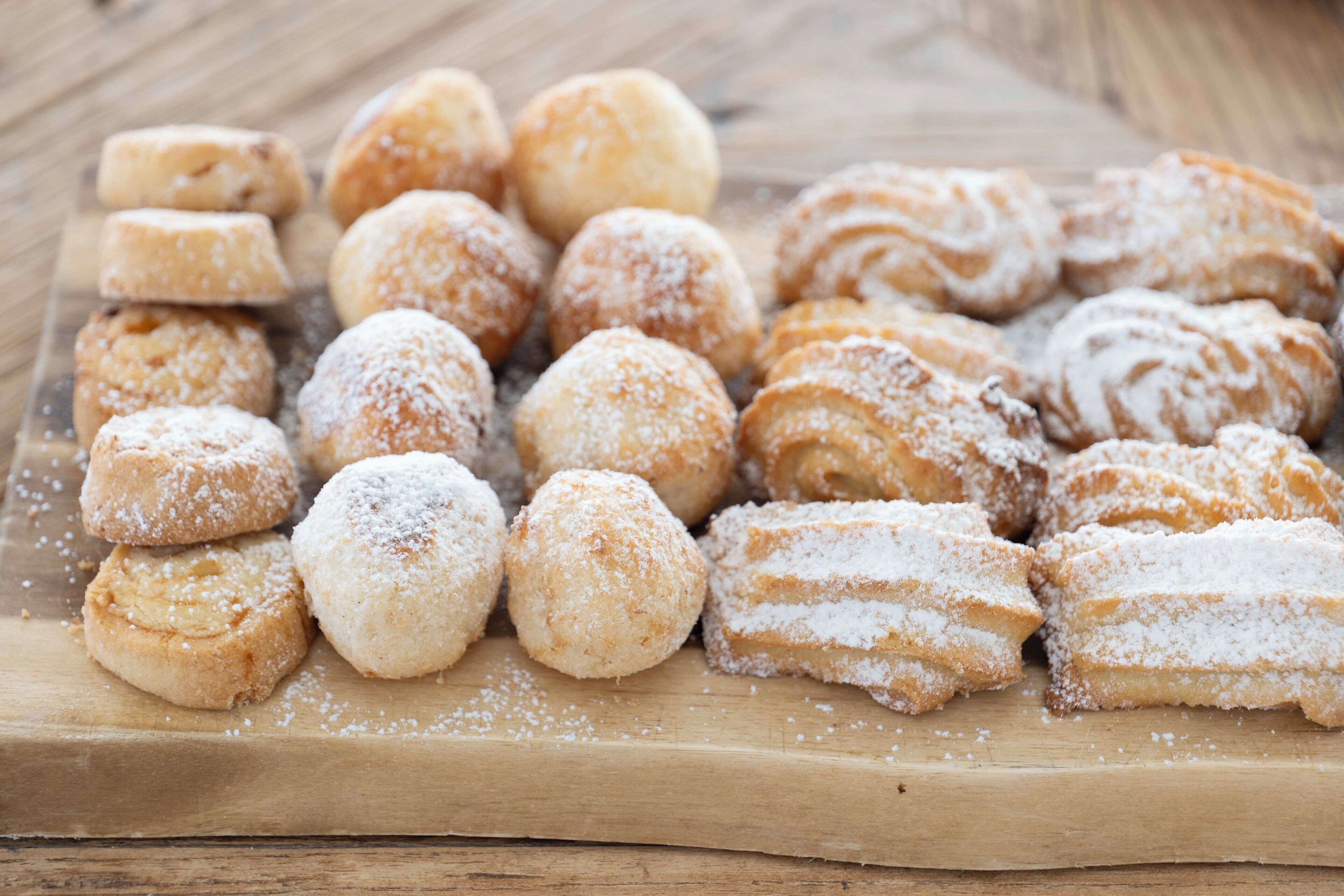 A variety of pastries on a wooden board.