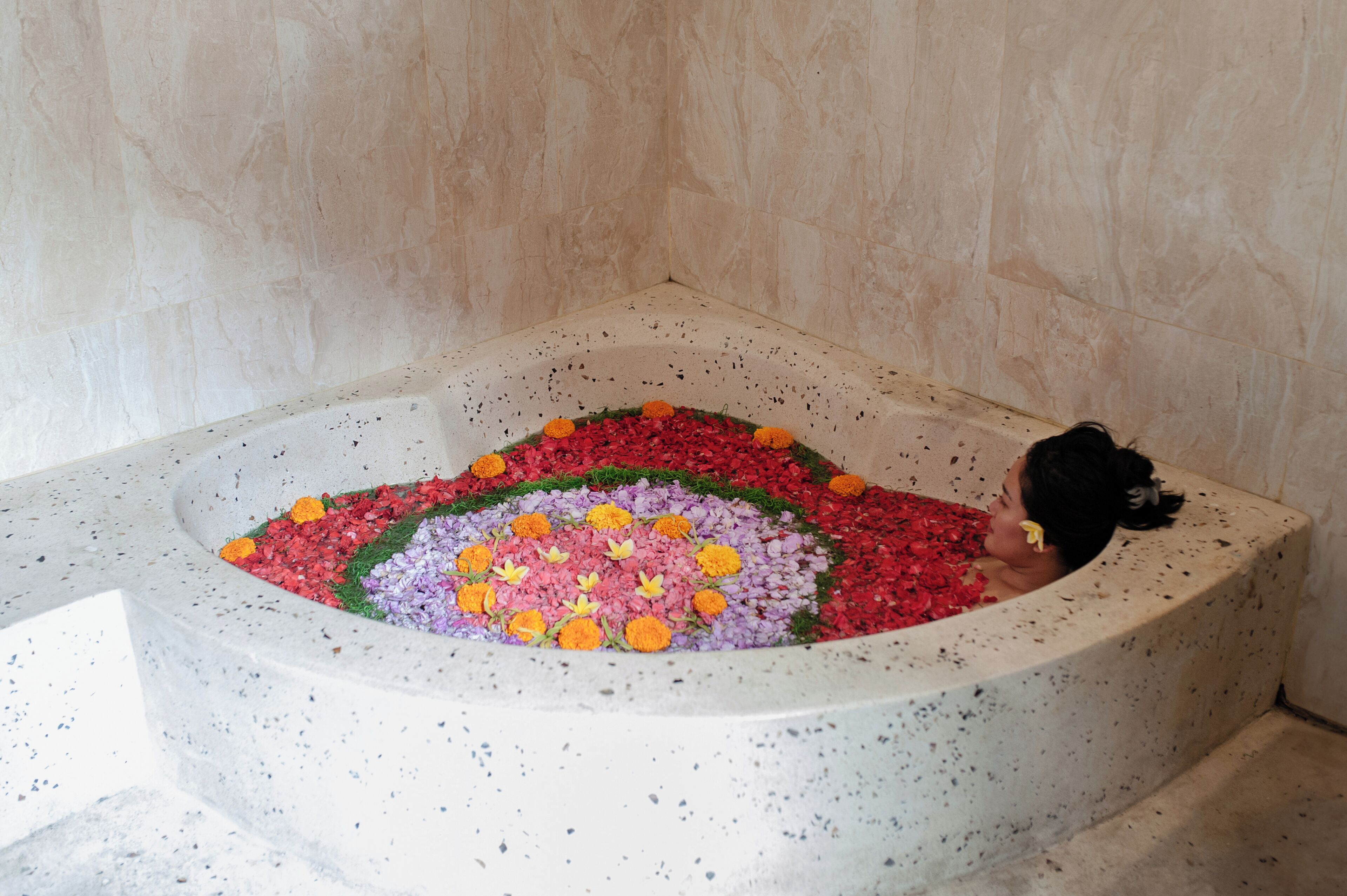 A bathtub filled with colorful flowers.