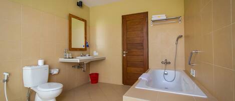 A bathroom with a toilet, sink, and bathtub.