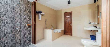 A bathroom with a shower, bathtub, toilet, and sink.