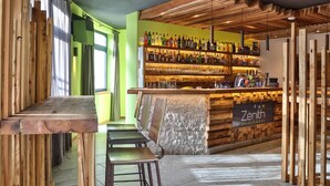 A bar area with wooden furniture and a shelf of bottles. - Sassdei My Active Suite Hotel (Andalo)