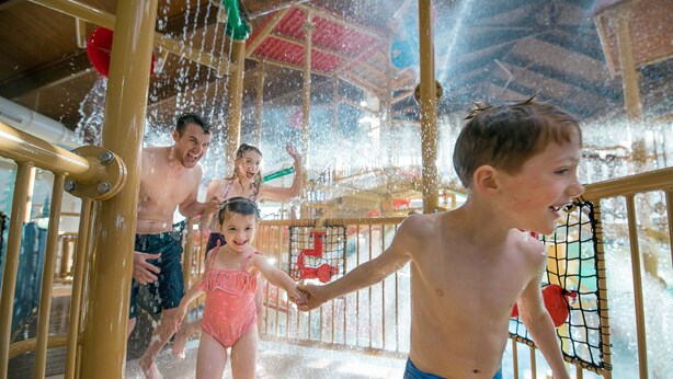 A water play area with children and adults.