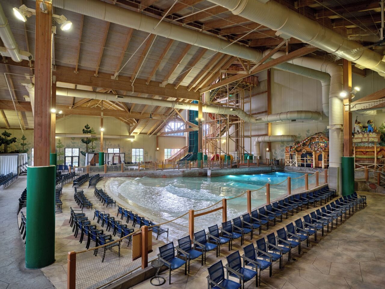 An indoor swimming pool with a spectator area and a stage.