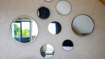 A wall with multiple round mirrors of varying sizes.