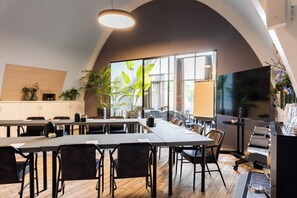 A modern kitchen with a large island, wooden flooring, and a large window with a view. - Hotel De Roode Schuur (Nijkerk)