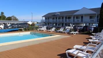 Seasonal outdoor pool, open 10:00 AM to 11:00 PM, pool umbrellas