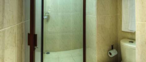 A bathroom with a shower, toilet, and a towel hanging on the wall.
