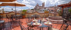 Enjoy al fresco dining on our patio, surrounded by lush greenery and historic architecture.