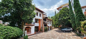 Hotel Grand San Javier offers a charming street view with a traditional facade and lush greenery.