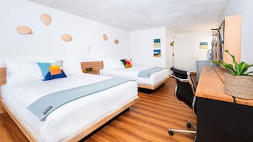 A modern hotel room with two beds, a desk, and a chair.