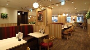 A restaurant interior with booths, tables, and chairs. - Centurion Hotel Ikebukuro (Tokyo)