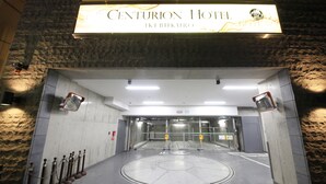 The entrance to Centurion Hotel with a sign above the doors, a tiled floor, and a chain barrier in front. - Centurion Hotel Ikebukuro (Tokyo)