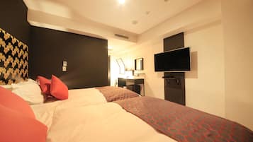A hotel room with two beds, a TV mounted on the wall, a desk with a chair, and a mirror.
