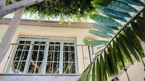 A staircase with metal railings and a window with metal bars. - Casa Florida (San Miguel de Allende)