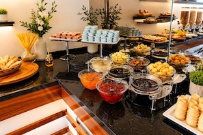 A buffet with various food items and condiments. - Burçman Hotel (Bursa)