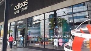 An adidas outlet store with large glass windows and a clear view of the interior. - Deluxe at Popular Condo (Pak Kret)