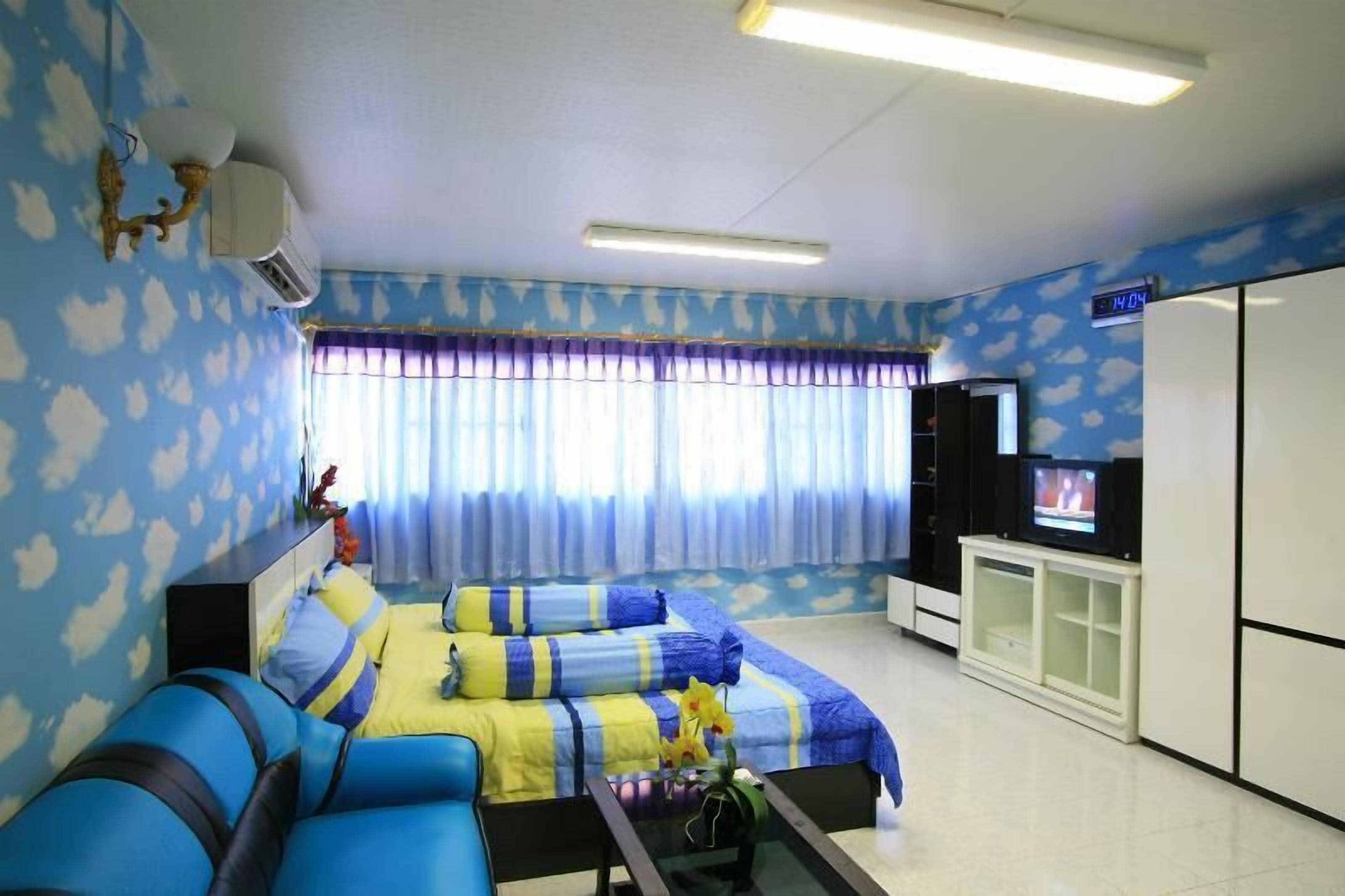 A living room with a sofa, a TV, and a cabinet.