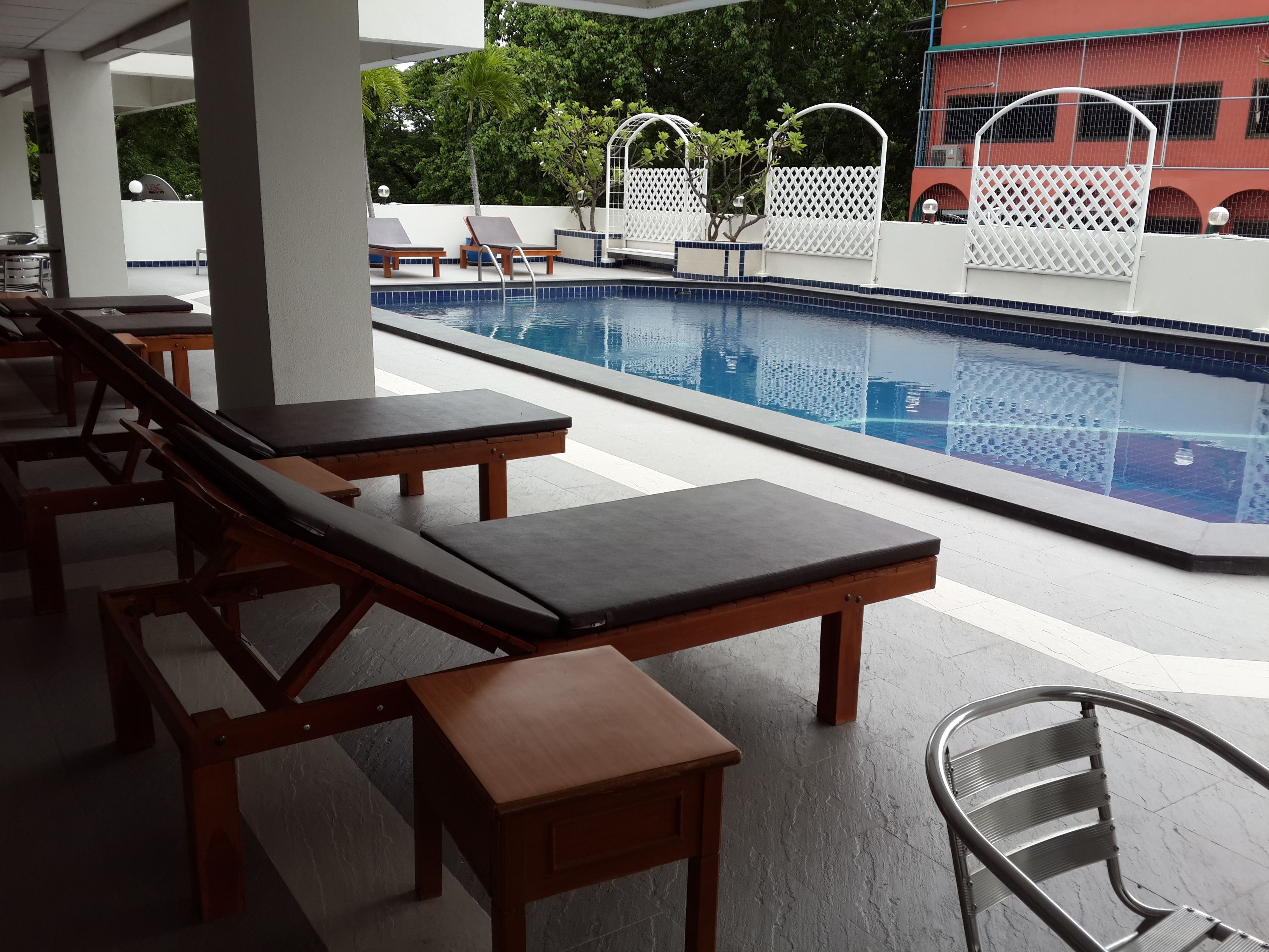 A pool area with lounge chairs and a clear view of the pool.