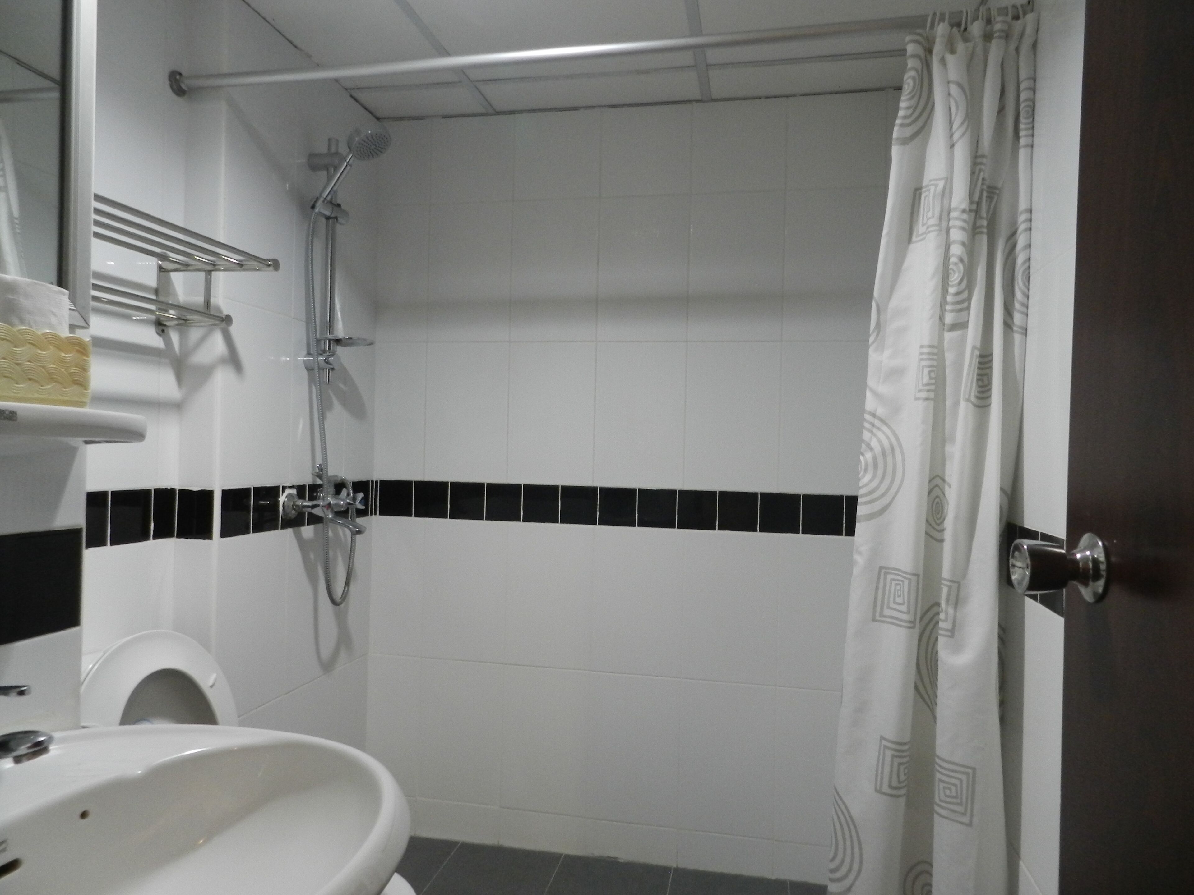 Ein Badezimmer mit Dusche, Toilette und Waschbecken.