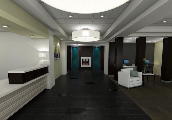 A modern lobby with a reception desk, seating area, and a large chandelier.
