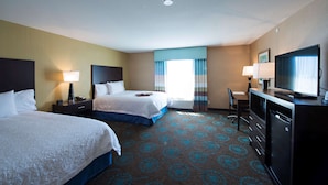 A hotel room with two beds, a desk, a television, and a minibar. - Hampton Inn Saskatoon South (Saskatoon)