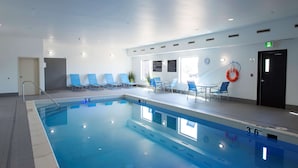 An indoor swimming pool with clear water, marked depth lines, and a lifebuoy on the wall. - Hampton Inn Saskatoon South (Saskatoon)