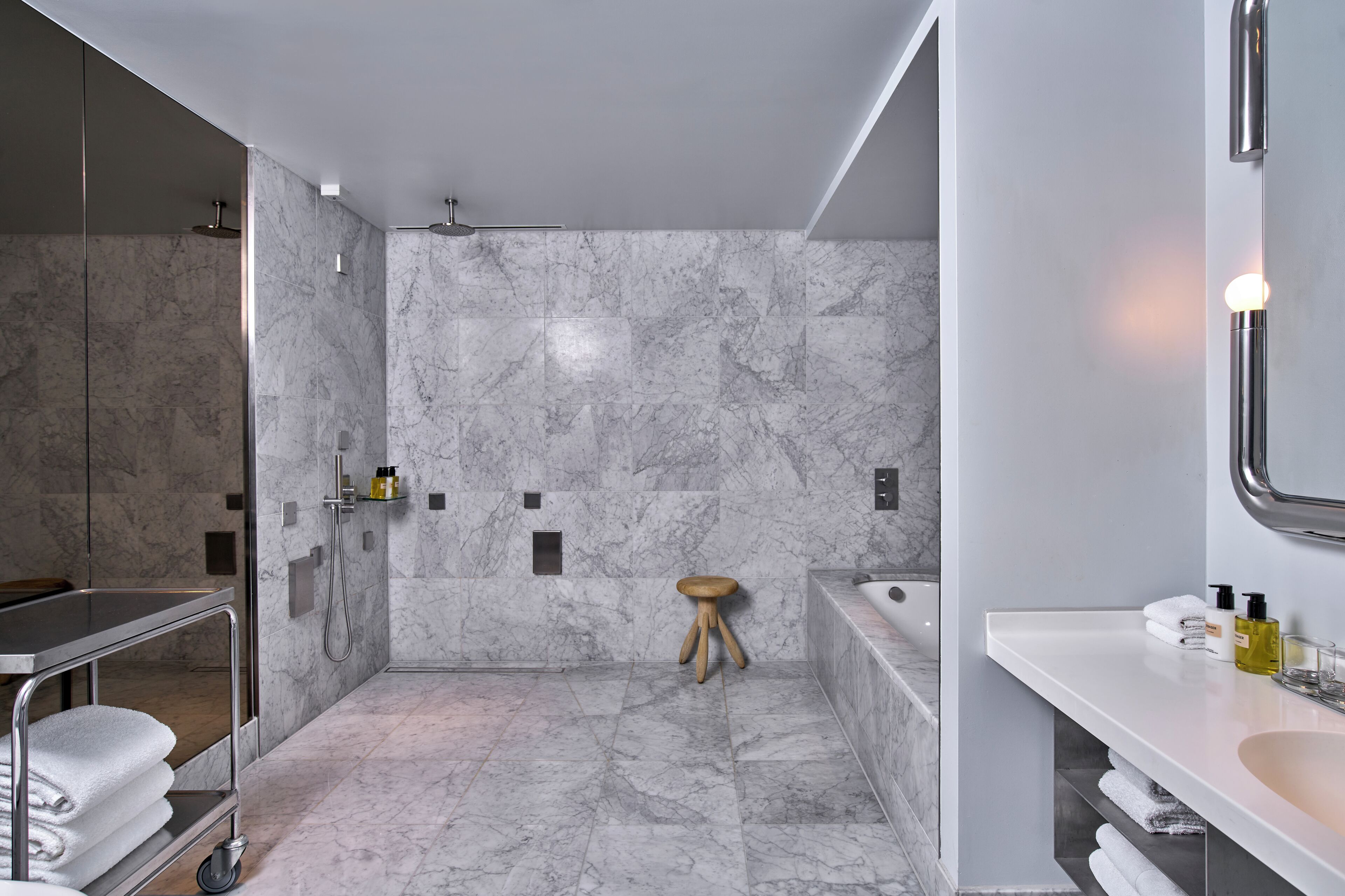 A modern bathroom with a shower, a bathtub, and a vanity with a mirror.