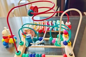 A wooden abacus with colorful beads and a red wire structure. - Shenhang International Hotel (Zunyi)