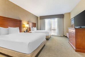 A hotel room with two beds, a TV, a dresser, and a lamp. - Drury Plaza Hotel Phoenix Tempe (Tempe)