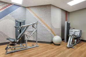 A gym with exercise equipment, a wall with geometric patterns, and a large exercise ball. - Drury Plaza Hotel Phoenix Tempe (Tempe)