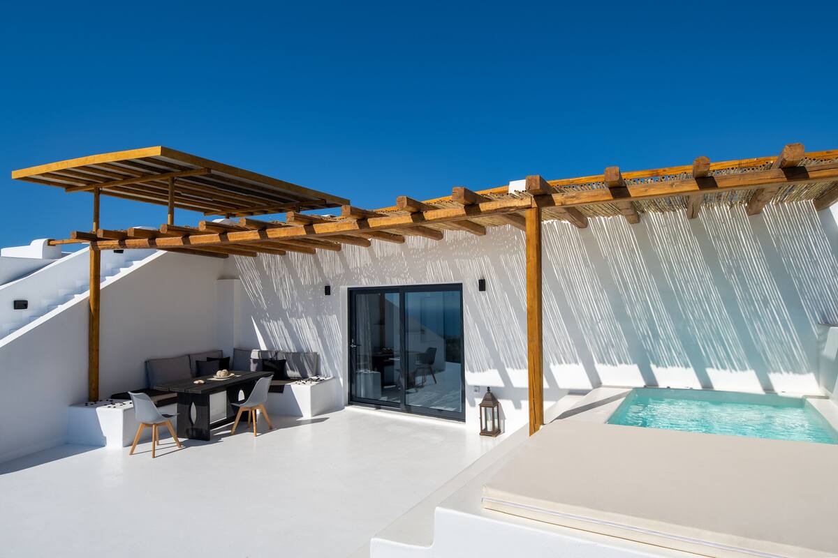A rooftop terrace with a pool, outdoor seating, and a pergola.