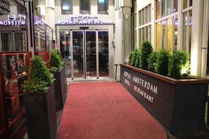 The entrance to the Royal Amsterdam Hotel with a red carpet, glass doors, and signage. - Royal Amsterdam Hotel (Amsterdam)