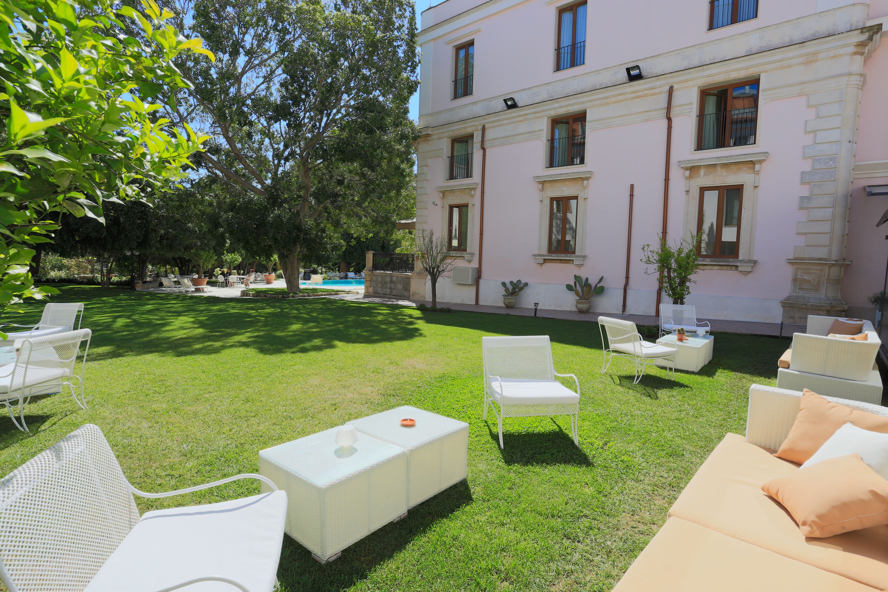 A courtyard with outdoor seating and a building in the background.