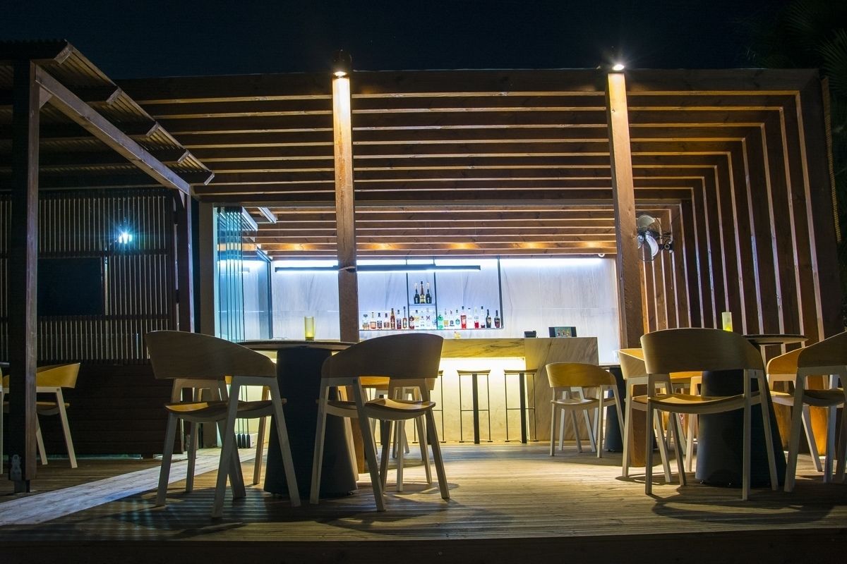 An outdoor bar area with wooden slats and a bar counter.