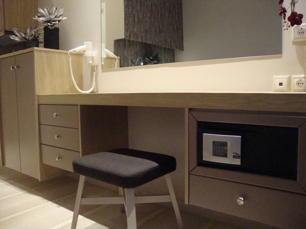 A modern bedroom with a bed, bedside table, and a nightstand.