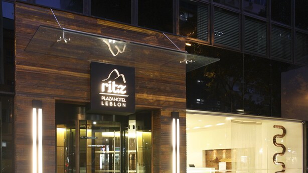 The exterior of the Ritz Plaza Hotel with a modern design, featuring a glass entrance and illuminated signage. - Ritz Hotel Leblon (Rio de Janeiro)