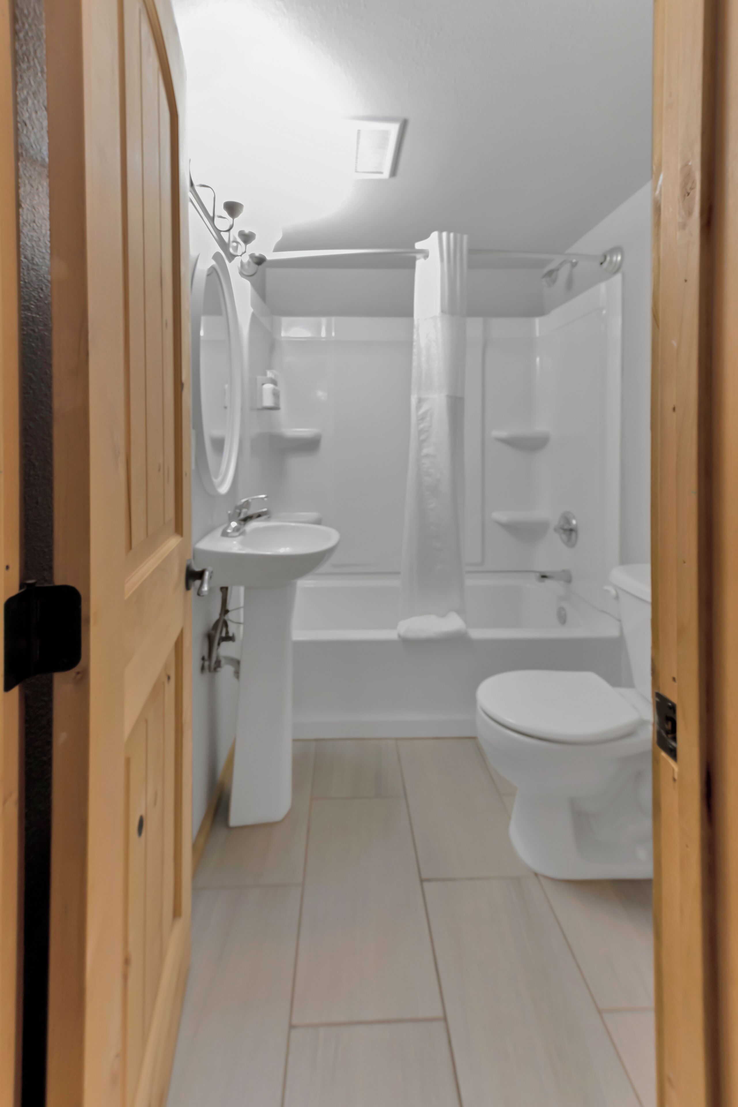 A bathroom with a toilet, sink, and bathtub.