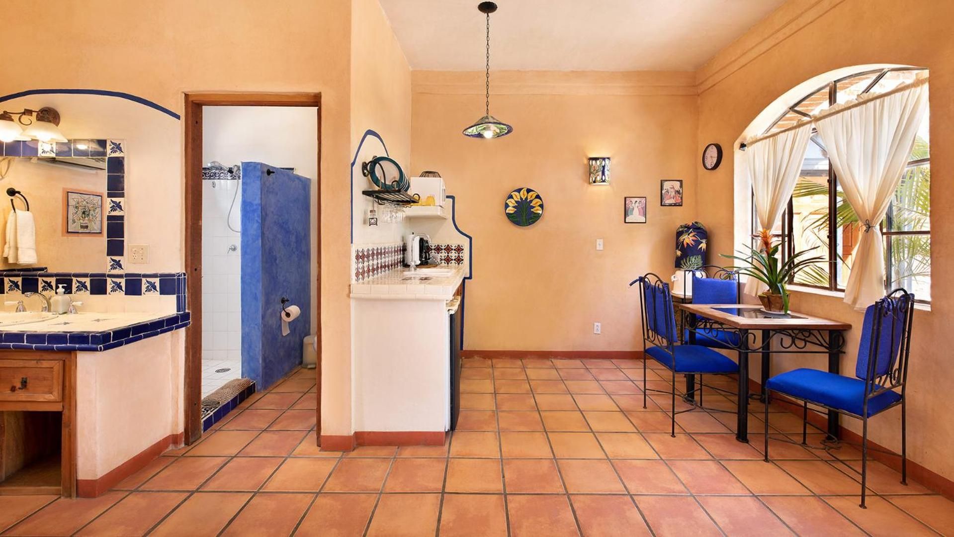 A compact living space with a kitchen, dining area, and a bathroom.