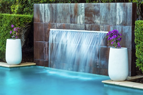 Outdoor pool, sun loungers. Springfield Lakes Boutique Hotel