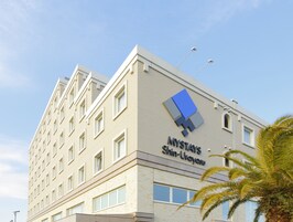 A multi-story hotel building with a prominent sign reading "MYSTAS Shin-Urayasu".