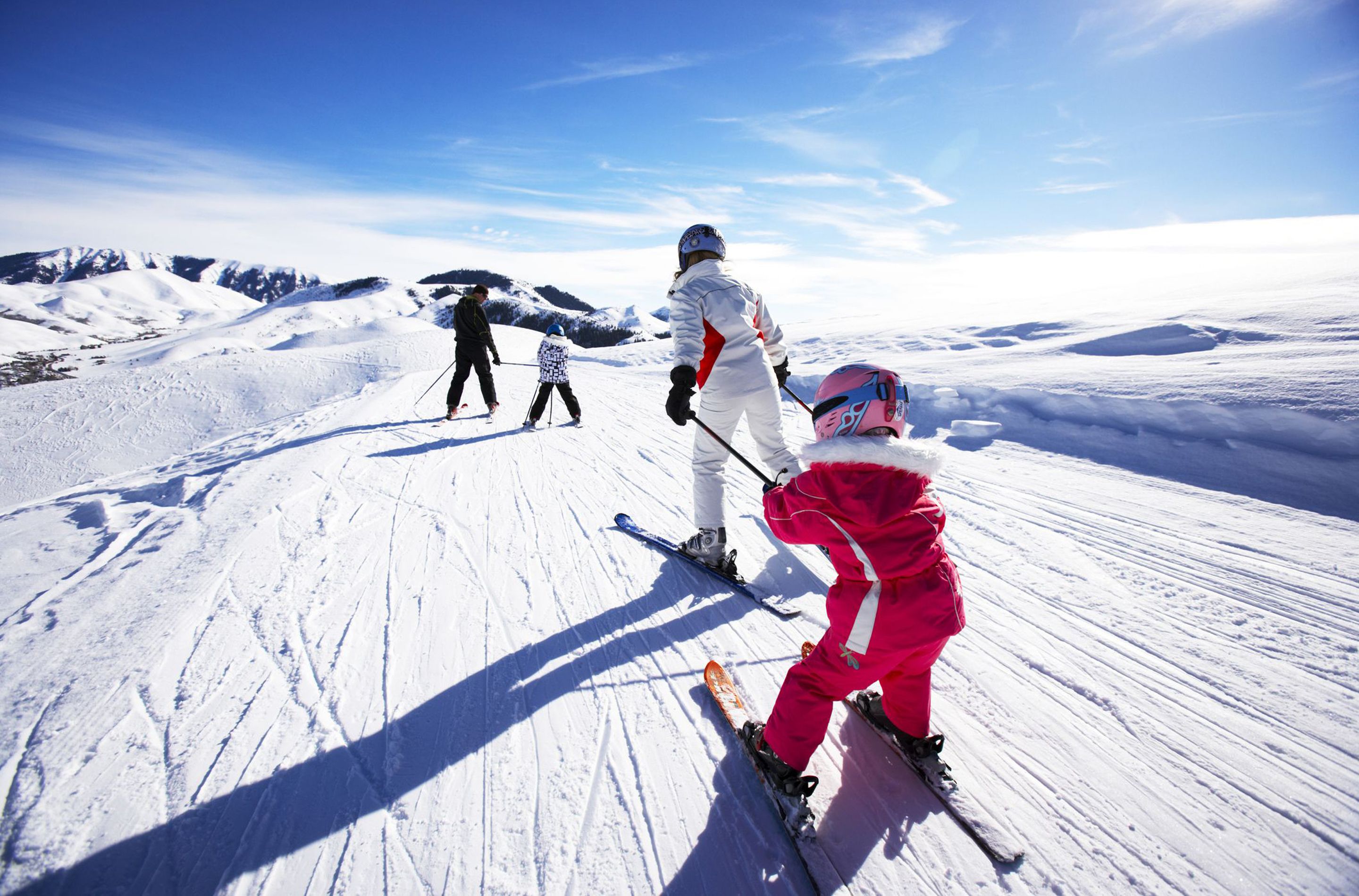 A snowy ski slope with skiers.