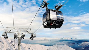 A cable car system with a clear view of the surrounding snowy mountain landscape.
