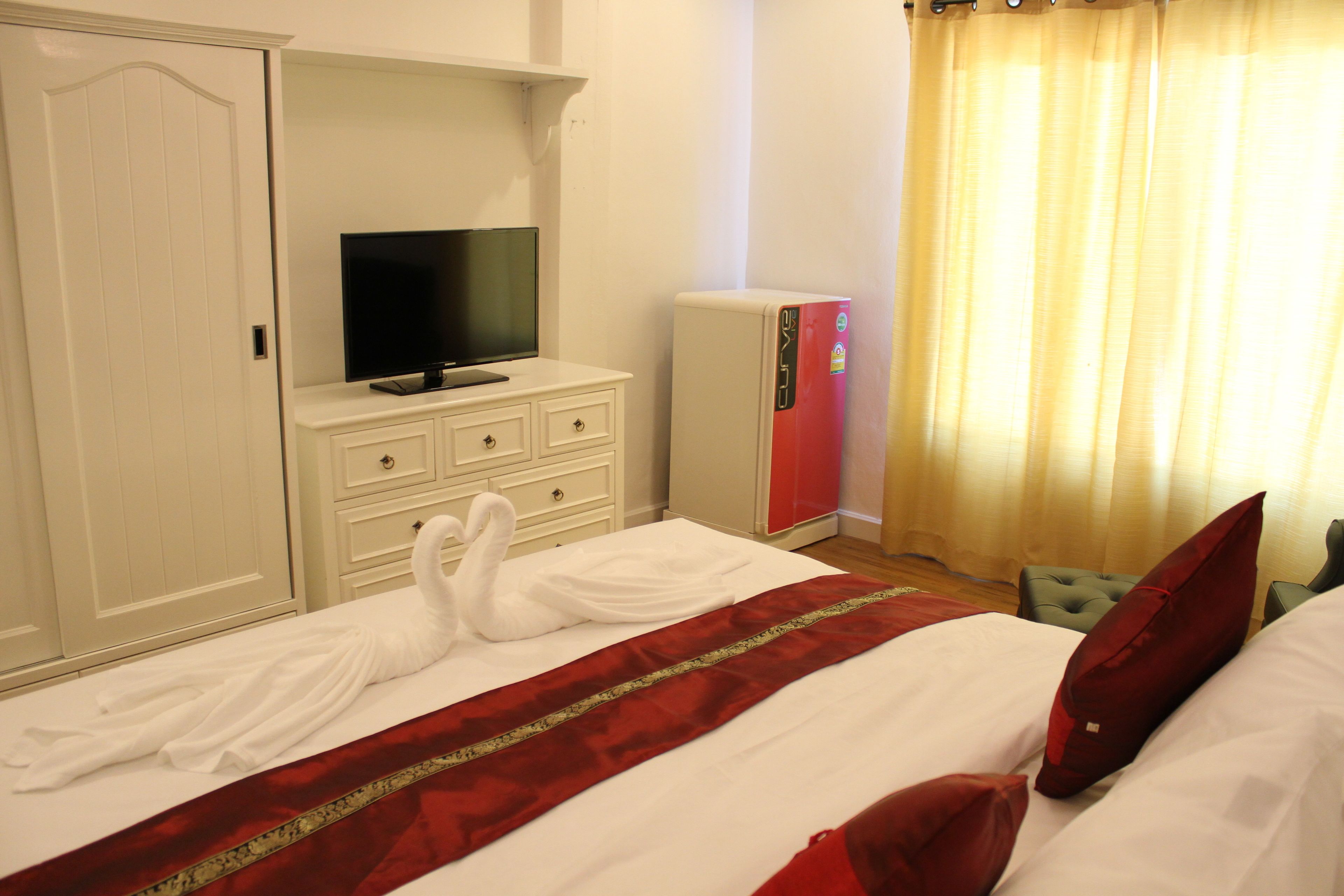 premium bedding, desk, laptop workspace, rollaway beds