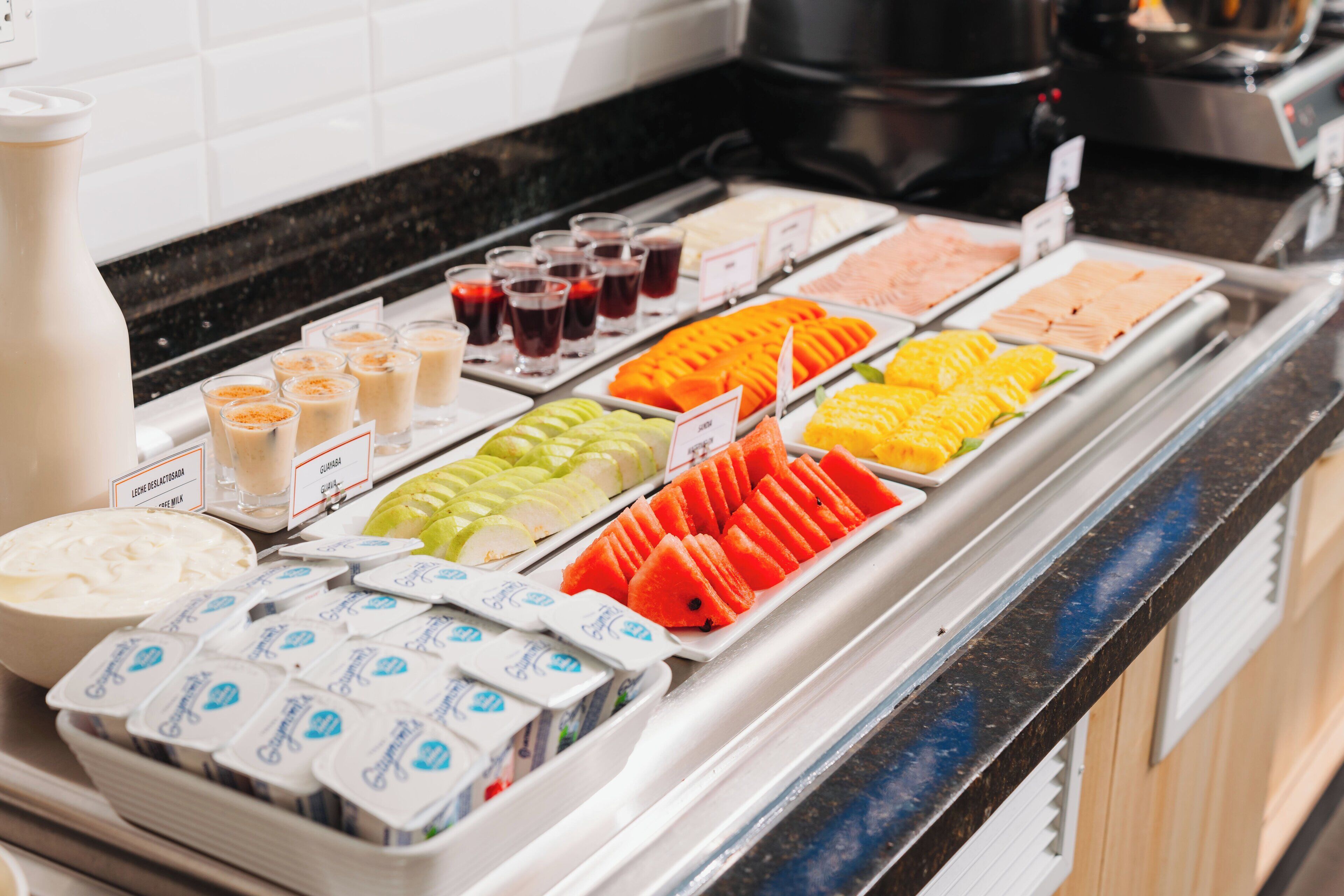 A buffet with various food items and beverages.