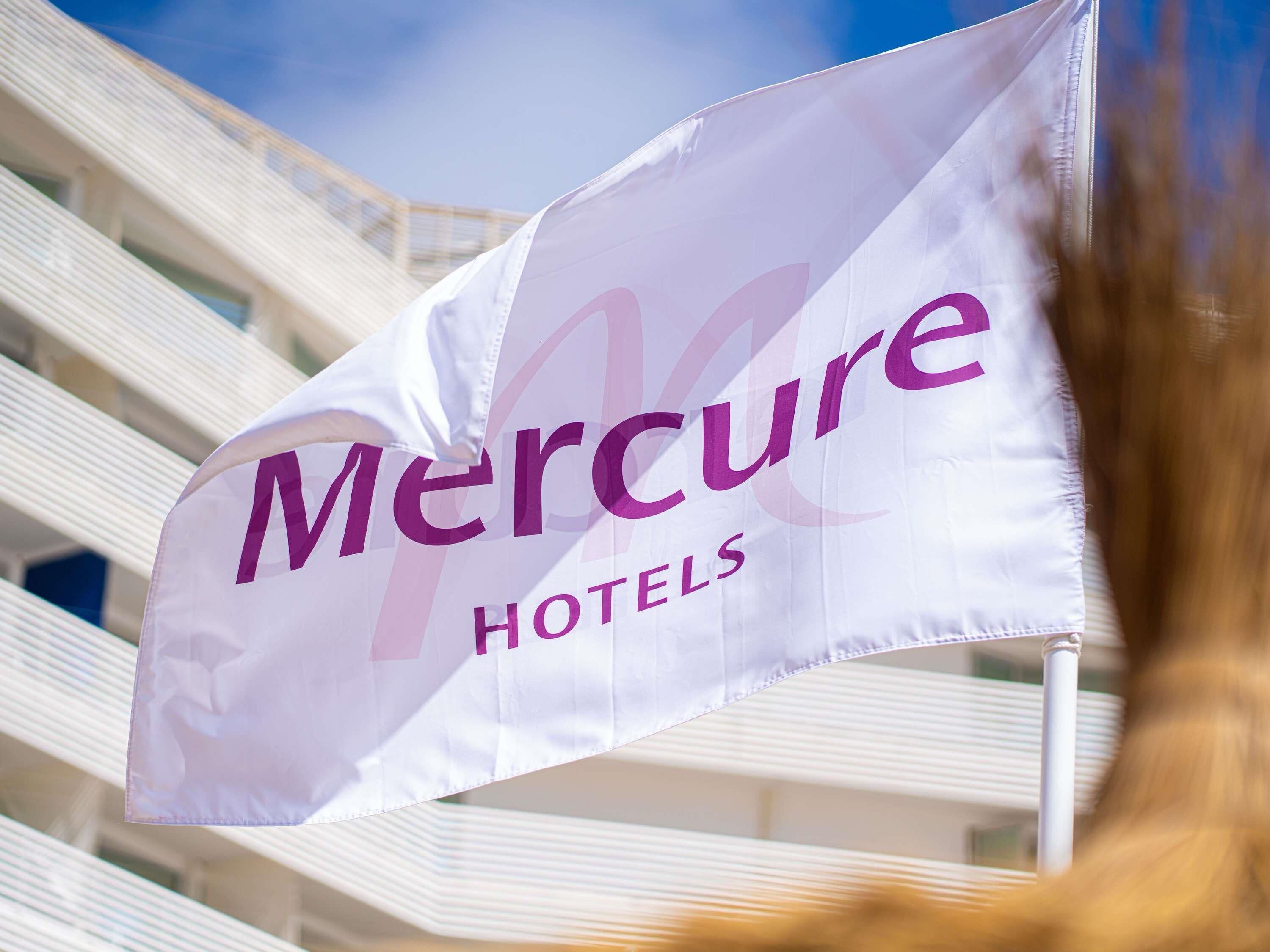 A Mercure Hotels flag with a stylized 'M' logo.