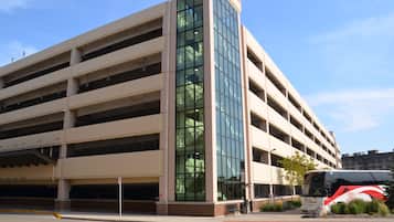 A multi-story parking garage with a modern design, featuring large glass windows and a flat roof.