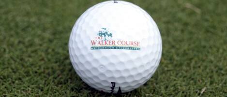 A golf ball with "The Walker Course" text and a logo on it.
