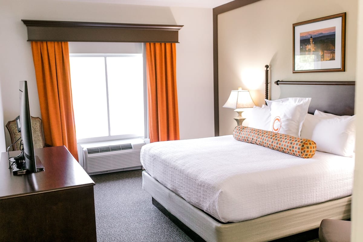 Premium bedding, desk, laptop workspace, blackout drapes