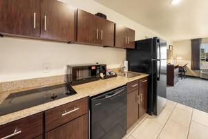 A modern kitchen with a built-in microwave, dishwasher, and refrigerator.